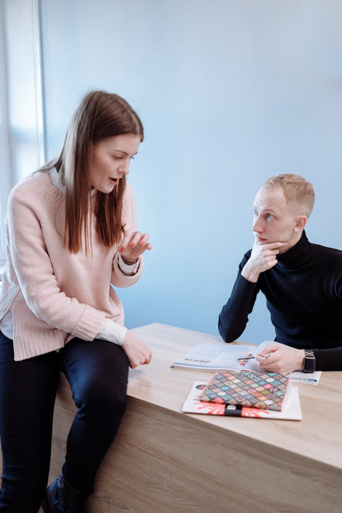 A teacher and student engage in a conversation in a study setting, fostering learning.