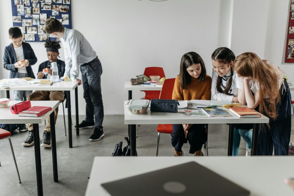 Students engage in group study and discussion in a contemporary classroom setting.