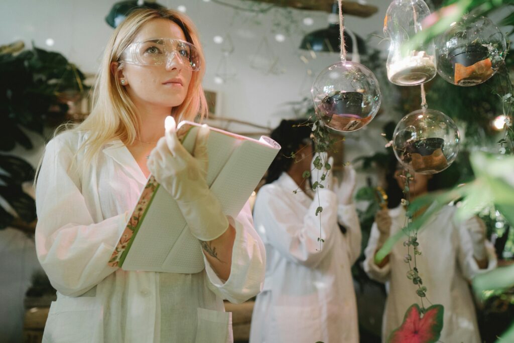 pexels-photo-8512663-8512663-1 Female scientist observing plant experiments in a lab setting.