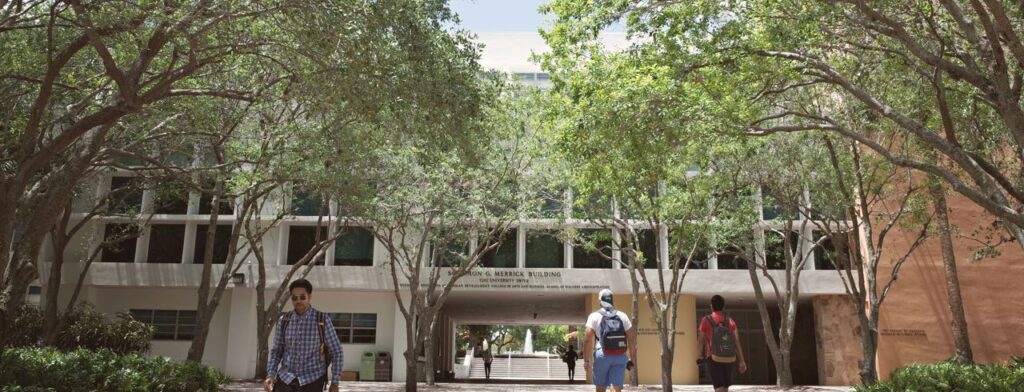 Students walking through a sunlit university campus in Coral Gables, Florida.